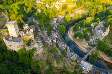 Scenic drone view of medieval village of Belcastel on banks of Aveyron River overlooking fortified...