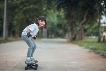 Cute little girl playing skateboard or surf skate in the skate park © FAMILY STOCK