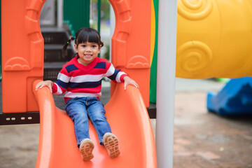 Fototapeta na wymiar Active little girl on playground