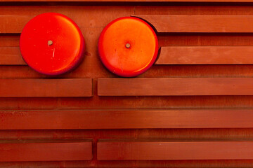Close up the alarm on  red wooden  wall background