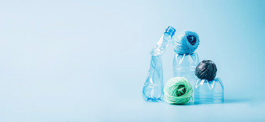 Plastic recycling and reuse concept. Empty plastic bottle and polyester fiber synthetic thread on a...