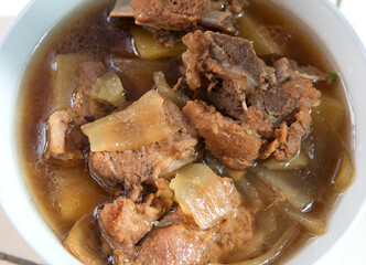 A bowl of braised pork ribs wide vermicelli