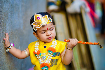 happy Janmashtami Greeting Card showing Little Indian boy posing as Shri krishna or kanha/kanhaiya...