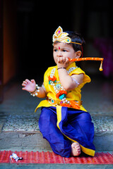 happy Janmashtami Greeting Card showing Little Indian boy posing as Shri krishna or kanha/kanhaiya...