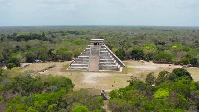 Forwards reveal of famous landmark Temple of Kukulcan. Aerial view of old stone pyramid. Historical monuments of pre-Columbian era, Chichen Itza, Mexico.