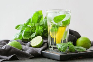 Glass of lemonade with basil on table