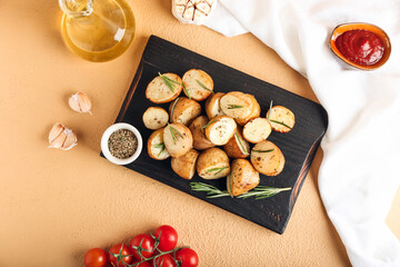 Board with baked potatoes on color background