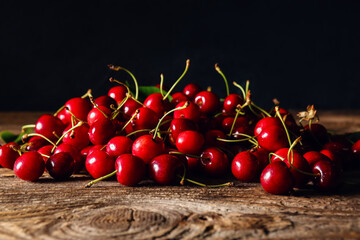 Heap of tasty ripe cherry on wooden table
