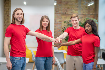 Group of young people in red tshirts indoors