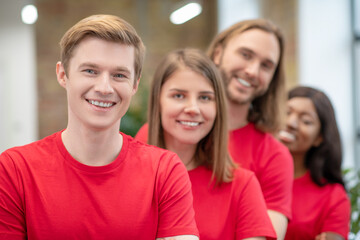 Happy faces of guys and girls volunteers