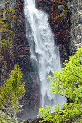 Fototapeta na wymiar Waterfall at a rock face in a canyon