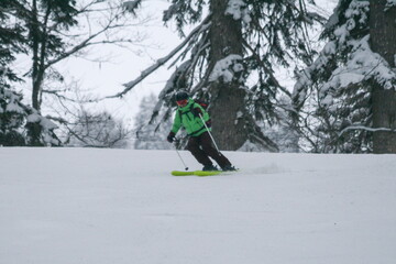 A young woman goes skiing on a ski track.