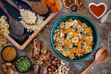 Granola bowl on the table with many berries, fresh fruits and nuts.