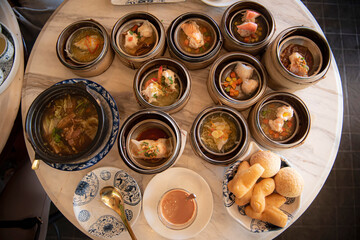 Top view Dim Sum in bamboo basket, Hot thai tea and deep-fried doughstick (patongko) 