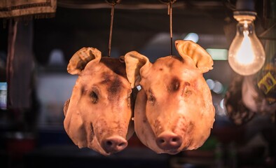 Pork head hanging for sale in the fresh market, Si Racha District Municipality, Thailand