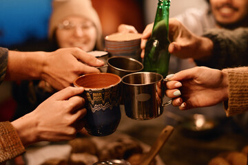Close-up of friends toasting with cups of drinks during party outdoors