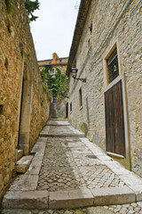 Fototapeta na wymiar A narrow street among the old houses of Bovino, a medieval village in the Puglia region.