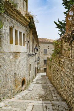 Fototapeta Bovino, Italy, June 23, 2021. A narrow street among the old houses of a medieval village in southern Italy.