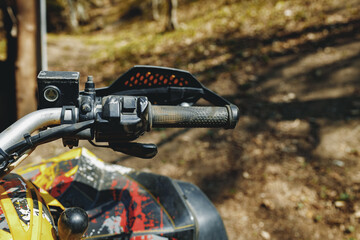 Handlebar of four-wheeled ATV quad bike close up