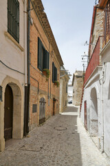 Bovino, Italy, 06/23/2021. A narrow street among the old houses of a medieval town with a Mediterranean style in the Puglia region.