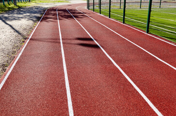 Red treadmill on sport field. Running track on the stadium