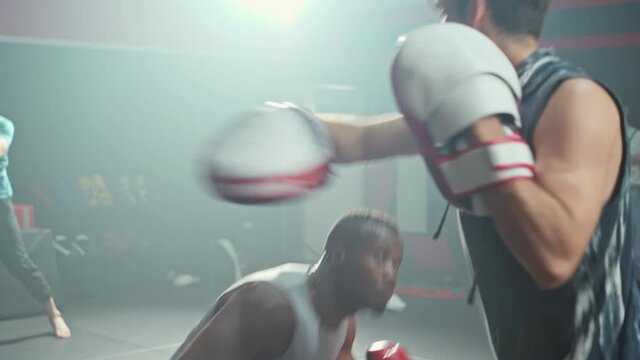 Fitness boxer trainer motivate sportsman exercise boxing, punch at gym