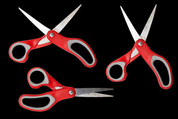 set scissors with a red handle isolated on black background