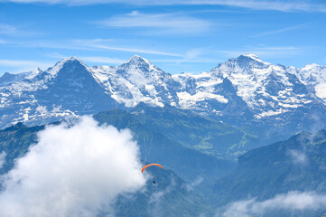 paragliding flyer in the Bernese Alps in front of Eiger Mönch and Jungfrau