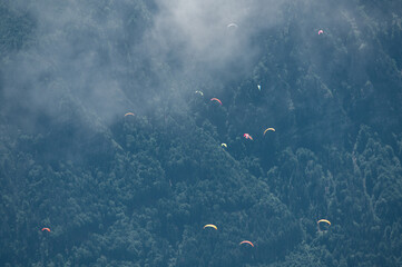 group of paragliding flyers in the Bernese Alps in front of Eiger Mönch and Jungfrau