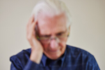 Defocused Concept Shot Of Senior Man Suffering With Mental Health Issues Like Dementia Or Alzheimers