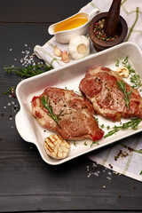 Grilled roated beef steaks in baking dish