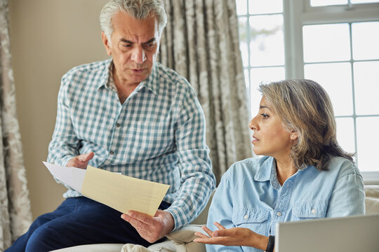Mature Couple At Home Having Argument About Domestic Finances