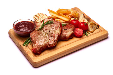 Grilled roated beef steaks, potato and sauce on wooden cutting board