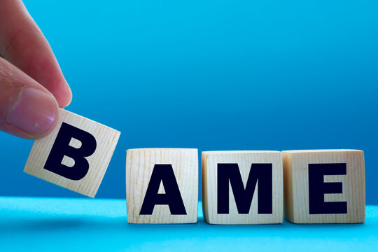 BAME Symbol. Abbreviation BAME, Black, Asian And Minority Ethnic On Wooden Cubes. Beautiful Blue Background. Copy Space. Business And BAME, Black, Asian And Minority Ethnic Concept.