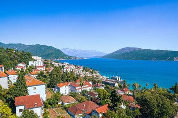 Summer view on houses with red roof and Bay of Kotor