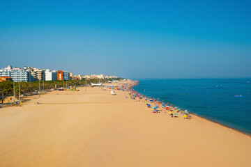 Fototapeta premium Long beautiful sandy beach in the resort town of Calella along the Mediterranean Sea, in the province of Barcelona, Costa Brava