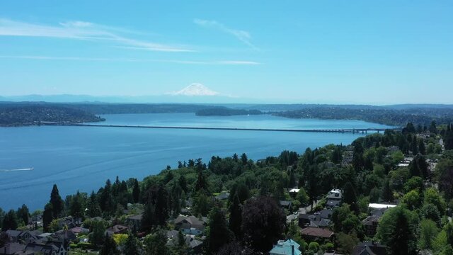 Drone flying over Madrona Neighborhood in Seattle with Lake Washington, Mt. Rainier, the I-90 Bridge and Mercer Island.