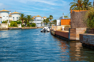 Beautiful and cozy resort town, Empuriabrava town in summer atmosphere, canal with yachts and small...