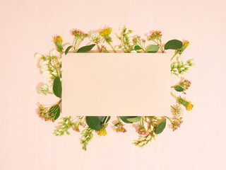 Blank paper with frame of flowers. Flat lay, copy space, top view.