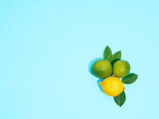 Composition with citrus fruits on blue background, top view.
