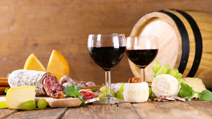 red wine glasses with salami and cheese