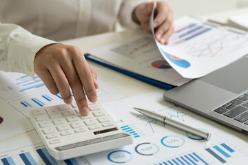 Business woman working in finance and accounting Analyze financial budget in the office