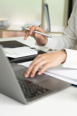 Business woman working in finance and accounting Analyze financial budget in the office