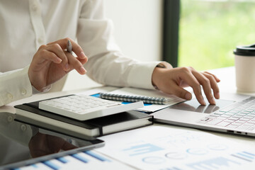 Fototapeta premium Business woman working in finance and accounting Analyze financial budget in the office