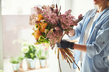 Woman making an exquisite spring floral arrangement