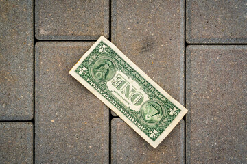 One dollar banknote lying on the ground