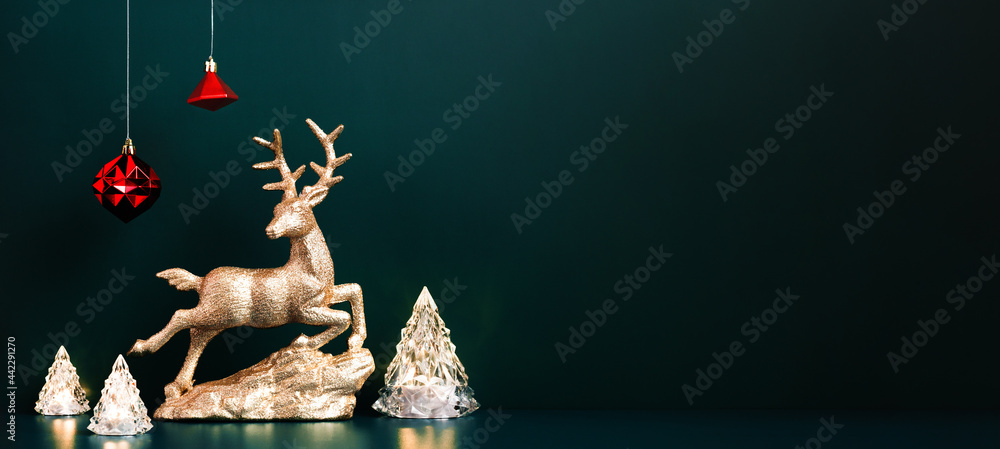 Poster christmas gold reindeer with xmas tree lamp lights with red baubles hanging on dark blue green backg