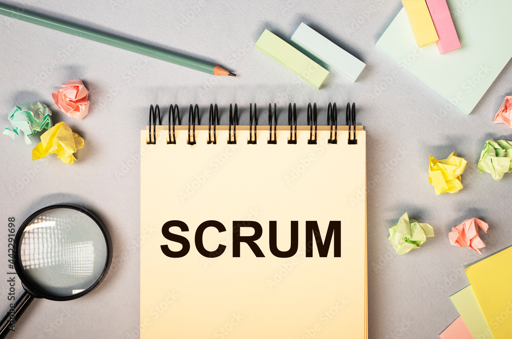 Poster scrum word on notepad on office desk, flat lay. concept of method in management.