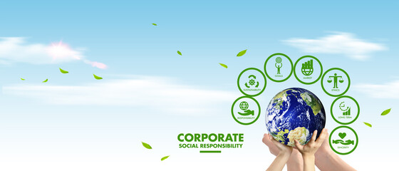 Corporate social responsibility (CSR) concept. Hands holding earth globe over sky background....