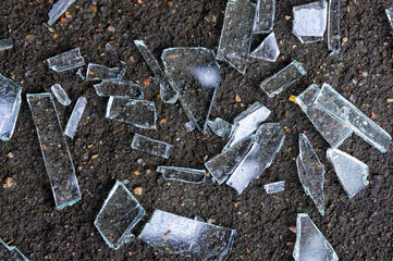 shards of broken glass on the asphalt close-up